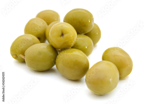 Green olives with leaves on a white background.