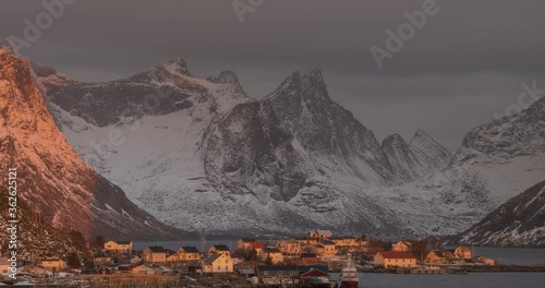 4K, 10bit, YUV422 timelapse of  Reine Village with the sun shines on the fisherman's cabins in sunrise, Hamnoy, Lofoten Islands, Norway