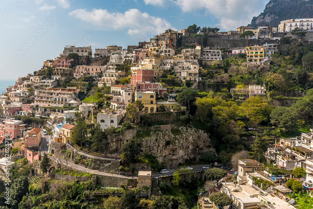 Pastel coloured buildings and the road snaking its way down the hillside in Positano on the Amalfi coast, Italy