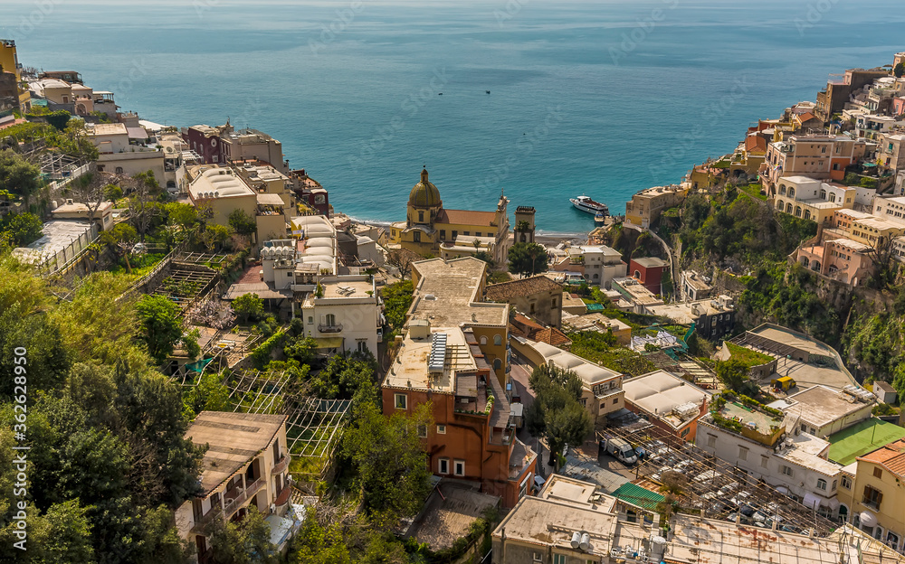 The domed church and pastel coloured buildings stretch down to the sea at Positano on the Amalfi coast, Italy