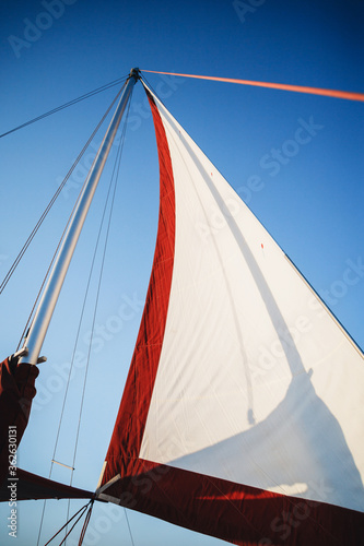 Top of the sailboat, mast head, sail and nautical rope yacht detail. Yachting, marine background photo
