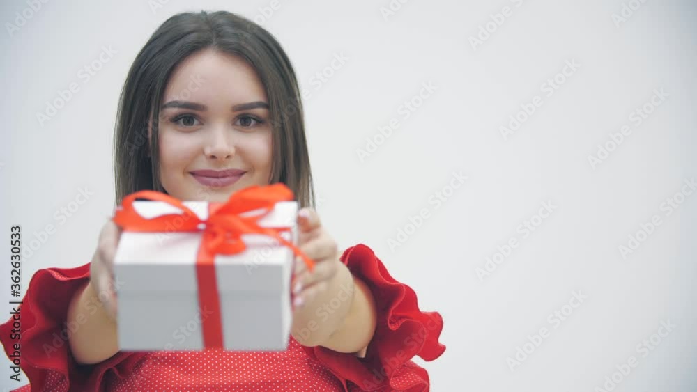 Slowmotion video of lovely girl in festive outfit ready for present exchange time on new year celebration. Slowmotion video of lovely girl in festive outfit ready for present exchange time on new year celebration.