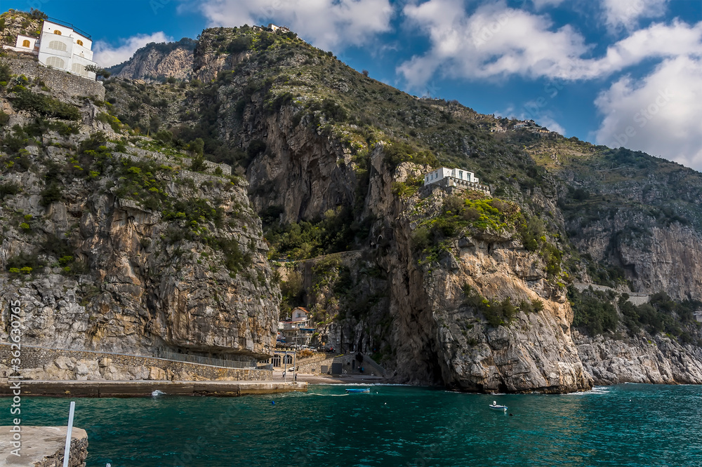 A deep ravine in the rocky coastline houses the settlement of Marina di Praia, Praiano, Italy