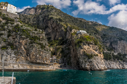 A deep ravine in the rocky coastline houses the settlement of Marina di Praia, Praiano, Italy