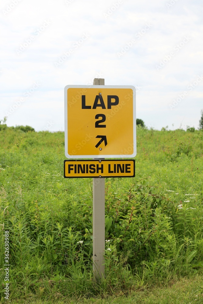 A close view of the yellow lap finish line sign.