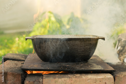 The cauldron on the fire. The pot on the fire.