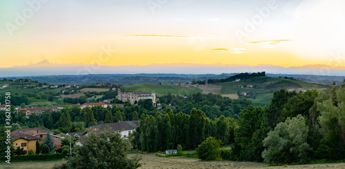 costigliole d asti town  view of the castle at dust sunset with monviso alps in background. Langhe monferrato wine region  piedmont  Italy