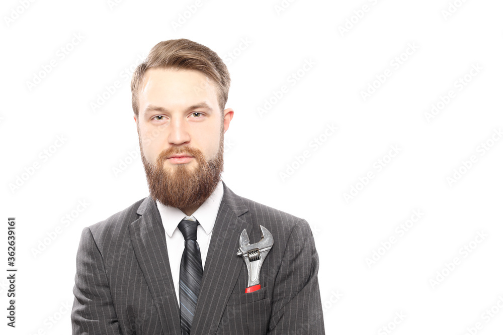Bearded man in suit and wrench inside pocket isolated on white background