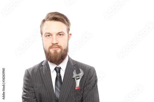 Bearded man in suit and wrench inside pocket isolated on white background