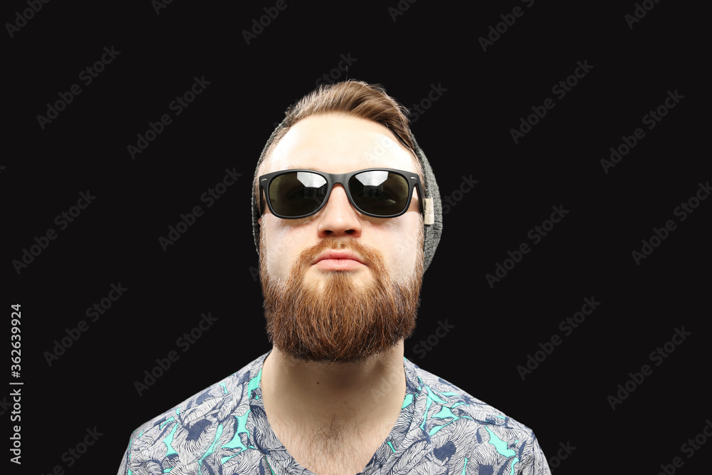 Obraz premium Bearded man in sunglasses isolated on black background
