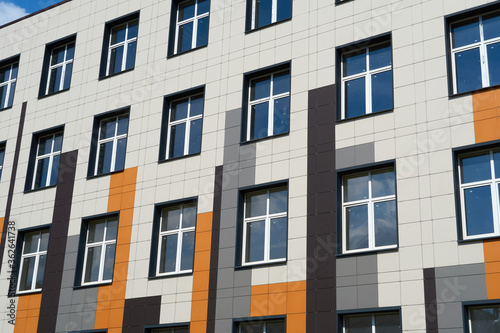 facade of a modern building on a bright Sunny day, siding and Windows, beautiful exterior of the new building © soleg