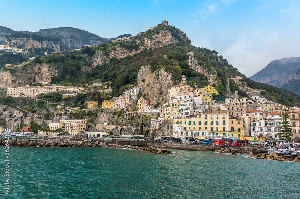 The seaside town of Amalfi, Italy sits beneath high cliffs