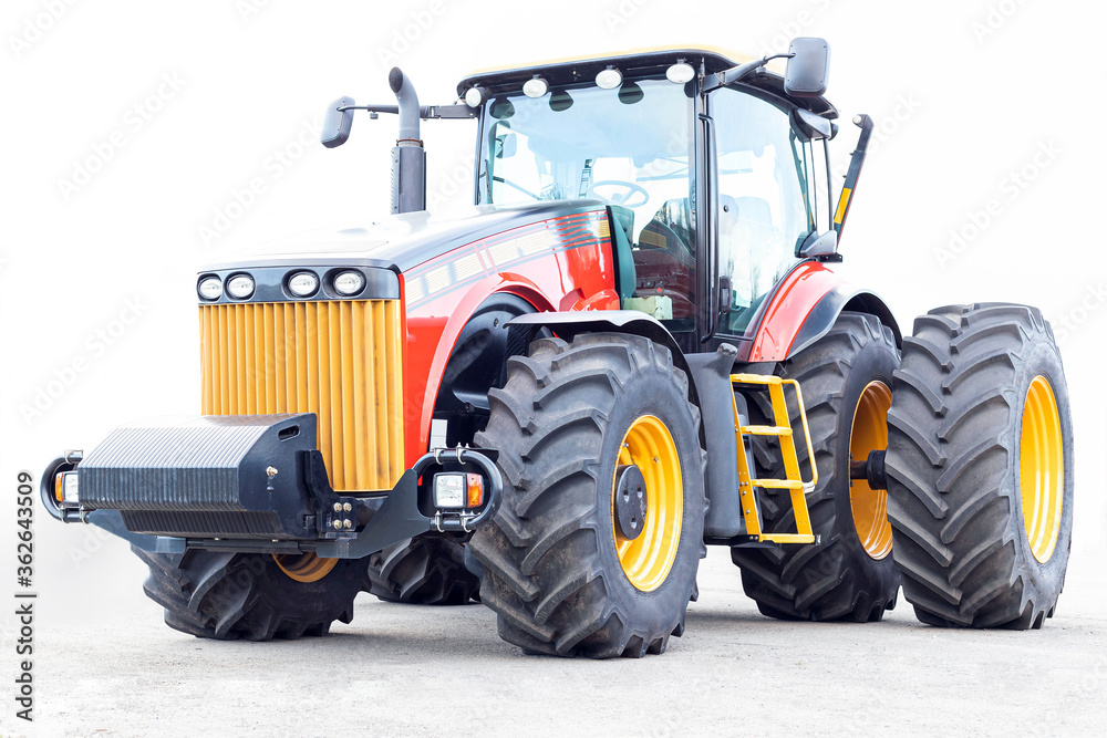 Obraz premium Big tractor on a white background. Agricultural machinery close-up.