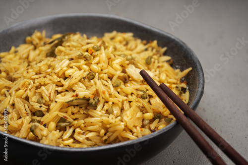 Kichari in a gray plate with Khasi sticks on the concrete surface close-up photo