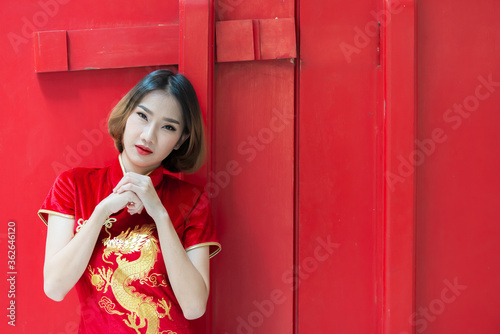 Portrait beautiful asian woman in Cheongsam dress,Thailand people,Happy Chinese new year concept,Happy asian lady in chinese traditional dress