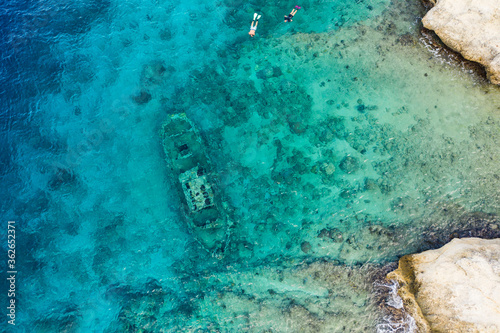 Aerial view of coast of Cura  ao in the Caribbean Sea with turquoise water  cliff  Tugboat beach and beautiful coral reef