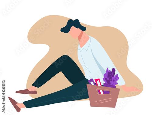 Frustrated unemployed man sitting by box with files