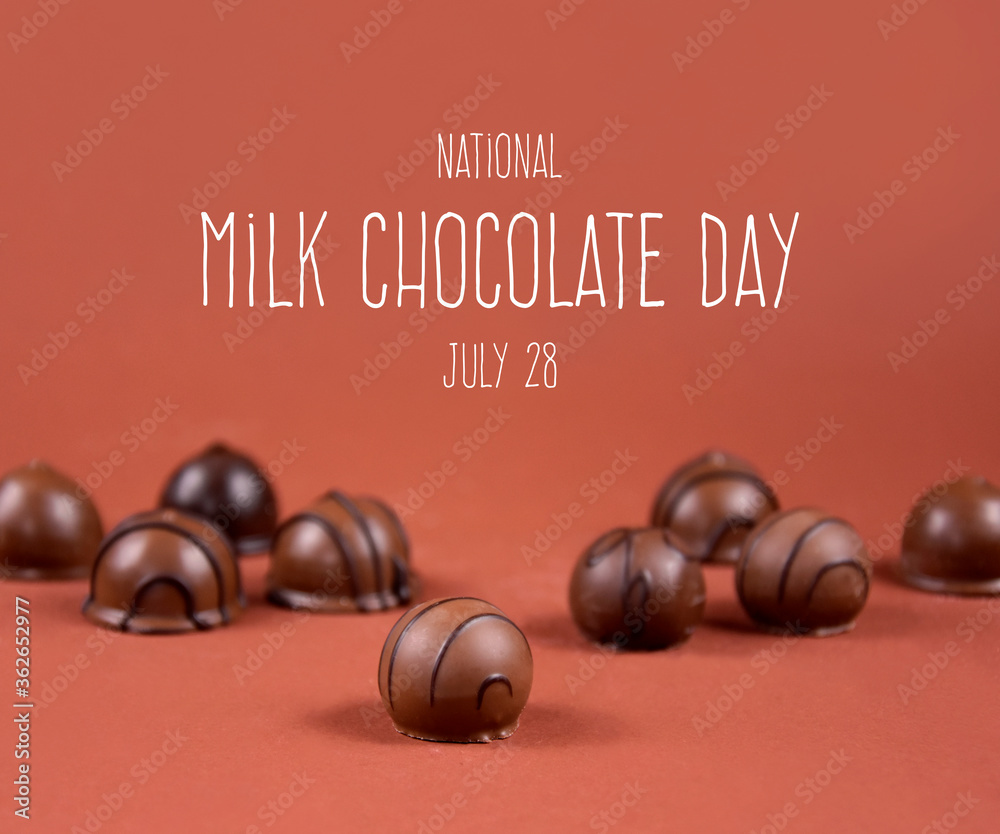 National Milk Chocolate Day stock images. Chocolate pralines on a brown