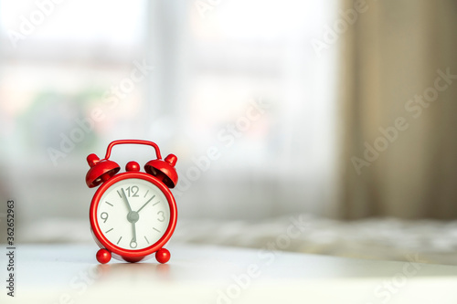 alarm clock on the bedside table in the morning, the concept of early rising to work
