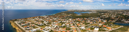 Fototapeta Naklejka Na Ścianę i Meble -  Aerial view of coast of Curaçao in the Caribbean Sea with turquoise water, cliff, beach and beautiful coral reef over Caracas Bay