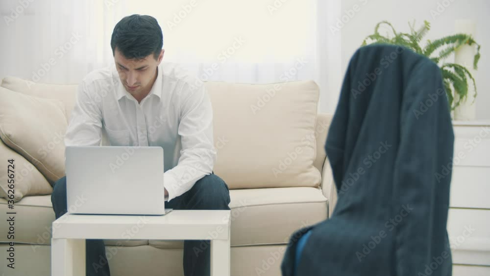Slowmotion video of mid adult caucasian manager typing on laptop in hotel room during business travel. Slowmotion video of mid adult caucasian manager typing on laptop in hotel room during business travel.