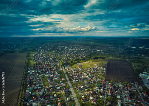 Aerial view from drone. Aerial view amazing sunset over of the suburbs with the city, far villages and fields