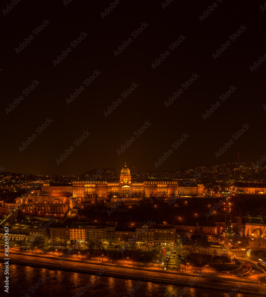 Aerial drone shot of Buda castle on Buda Hill in Budapest night with city lights on Aerial drone shot of Buda castle on Buda Hill in Budapest night with city lights on