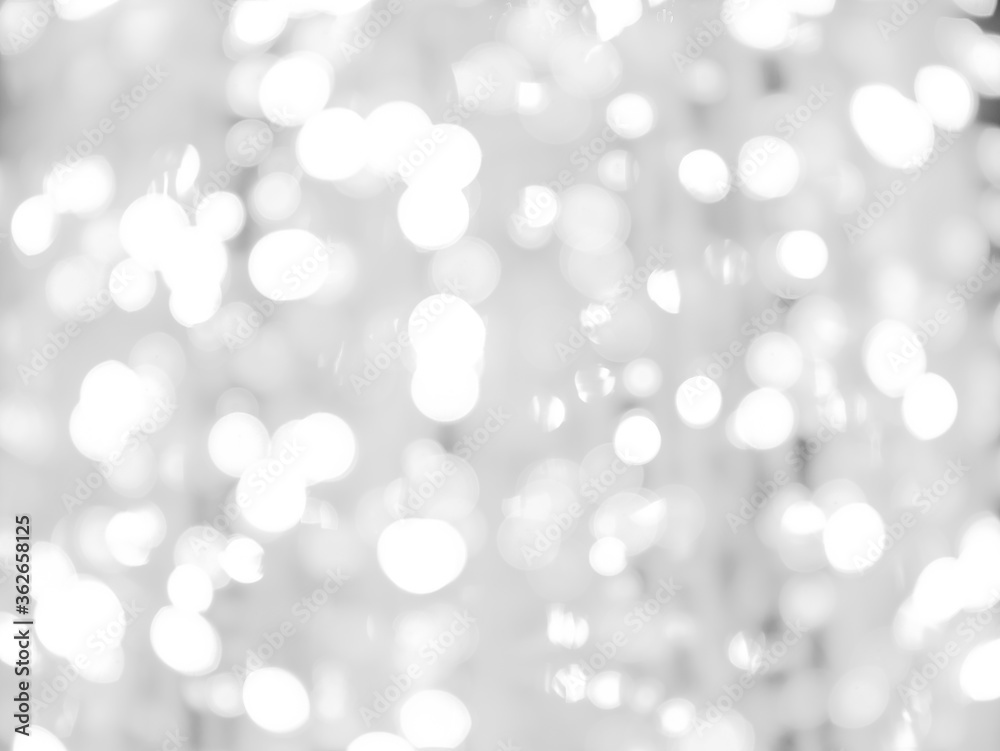 blurred bokeh light defocused background and textured for Christmas , New Year holidays party and celebration background, black and white colour