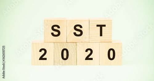 Sales and Service Tax (SST) 2020 words on wooden blocks business concept