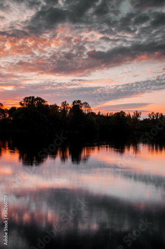 Colorful sunset sky with perfect idyllic water lake reflections