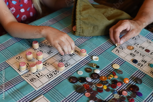 Grandma and granddaughter play Lotto.