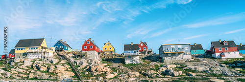 Greenland view of houses in Ilulissat City and icefjord. Tourist destination in the actic. Panoramic photo of typical Greenland village houses. photo