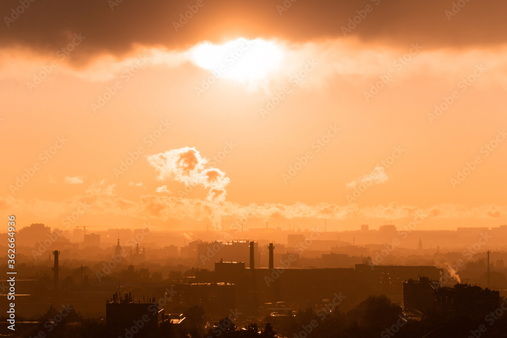 Beautiful orange sunset over the city of Ryazan in summer. Far away smoke from the factory in the rays of sunset