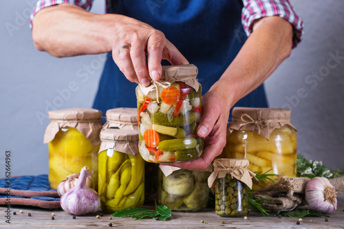 Homemade preserved and fermented food, pickled and marinated vegetables photo