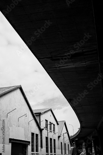 View from under a highway in black and white.