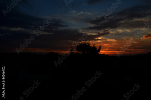  colorful sunset with red sky and trees and clouds