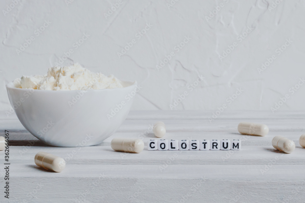 Fototapeta premium Pills capsules with colostrum, on a white background