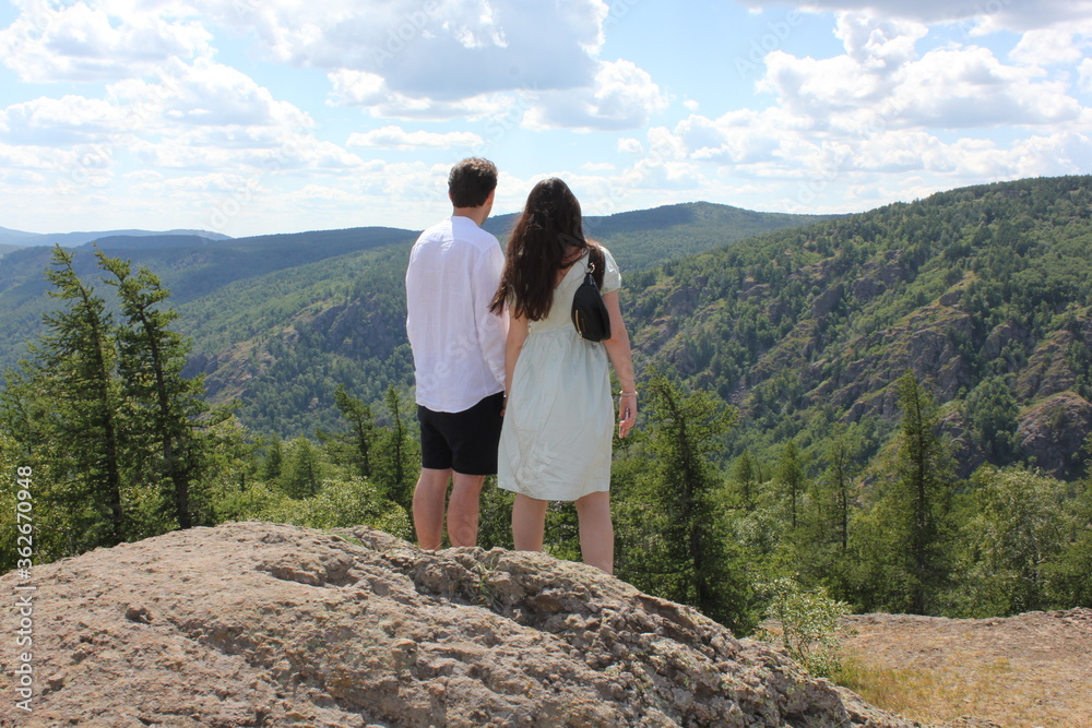 Naklejka premium Happy travelers man and women on the top of mountain. Travel adventure lifestyle success concept hiking active vacations