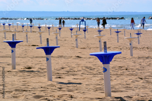 Termoli, Molise,  Italy. Prevention rules  for social distancing in bathhouse on a sandy beach. photo