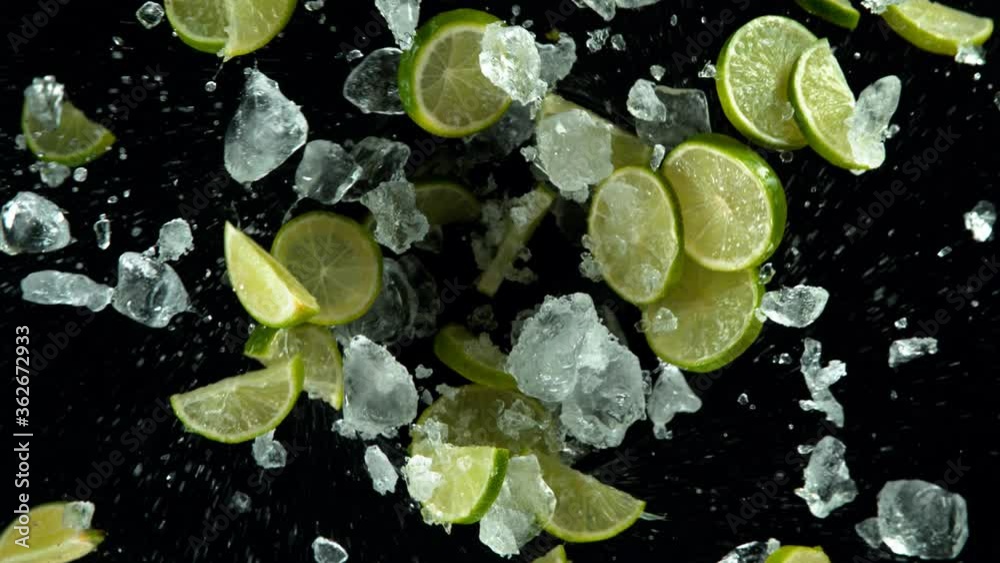 Super slow motion of lime slices with ice rotating in water, black background. Filmed on high speed cinema camera, 1000 fps. Super slow motion of lime slices with ice rotating in water, black background. Filmed on high speed cinema camera, 1000 fps.