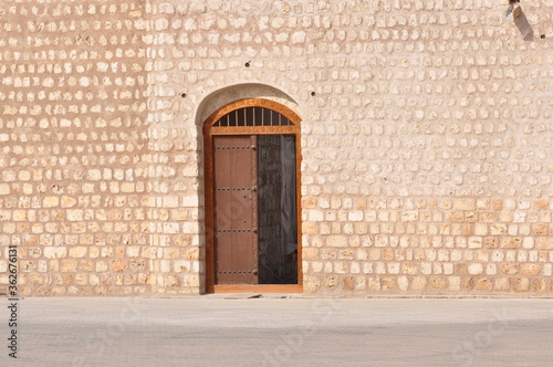 Wooden door and Coral wall of arab architecture ,sharjah Uae .
