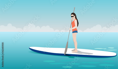Young woman standing on sup board
