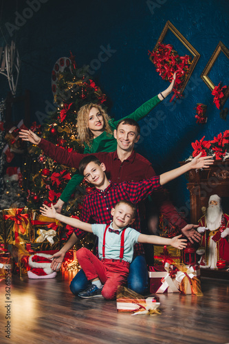 A family with two sons in a new year or Christmas interior