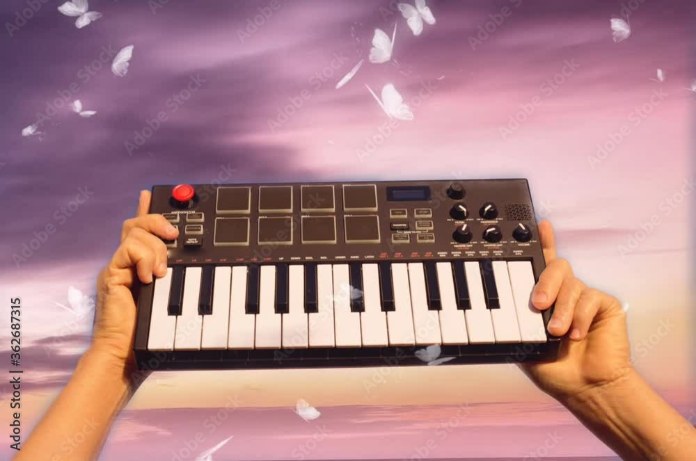 Hands holding music piano keyboard background sky butterflies sunset