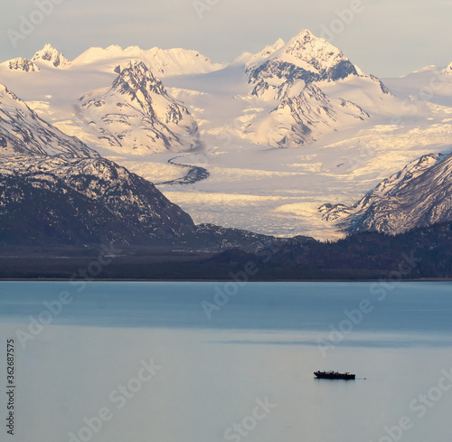 Grewingk Glacier glows with the pink of sunset on the shores of Kachemak Bay photo