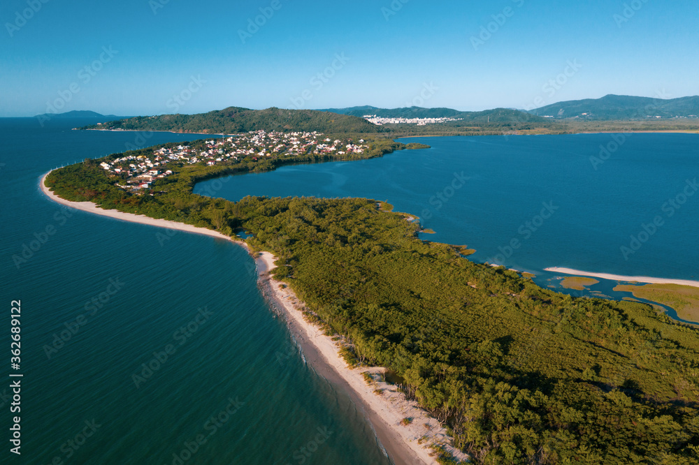 Brazil, Florianopolis. Panoramic aerial view of Daniela beach pontal peninsula and river showing sea, sand, trees and an the village. Brazil, Florianopolis. Panoramic aerial view of Daniela beach pontal peninsula and river showing sea, sand, trees and an the village.