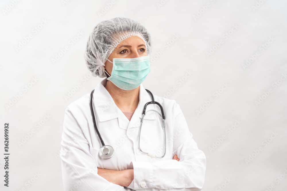 Tired female medic, nurse in protective equipment and a mask from viruses, on a white background. With a stethoscope. Tired female medic, nurse in protective equipment and a mask from viruses, on a white background. With a stethoscope.