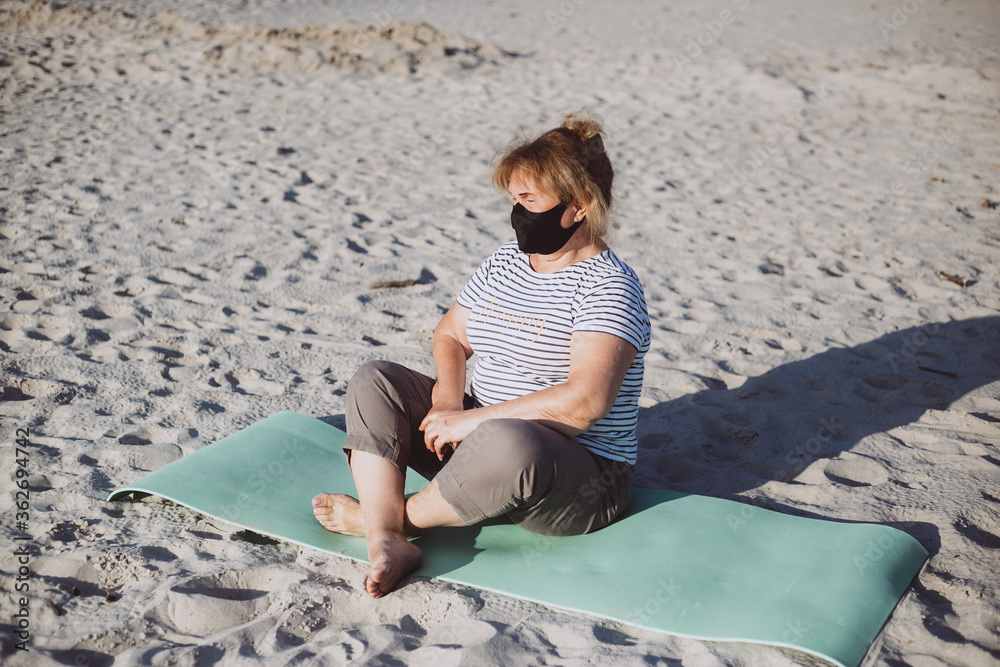 senior woman wearing medical mask on nature. coronavirus concept. respiratory protection