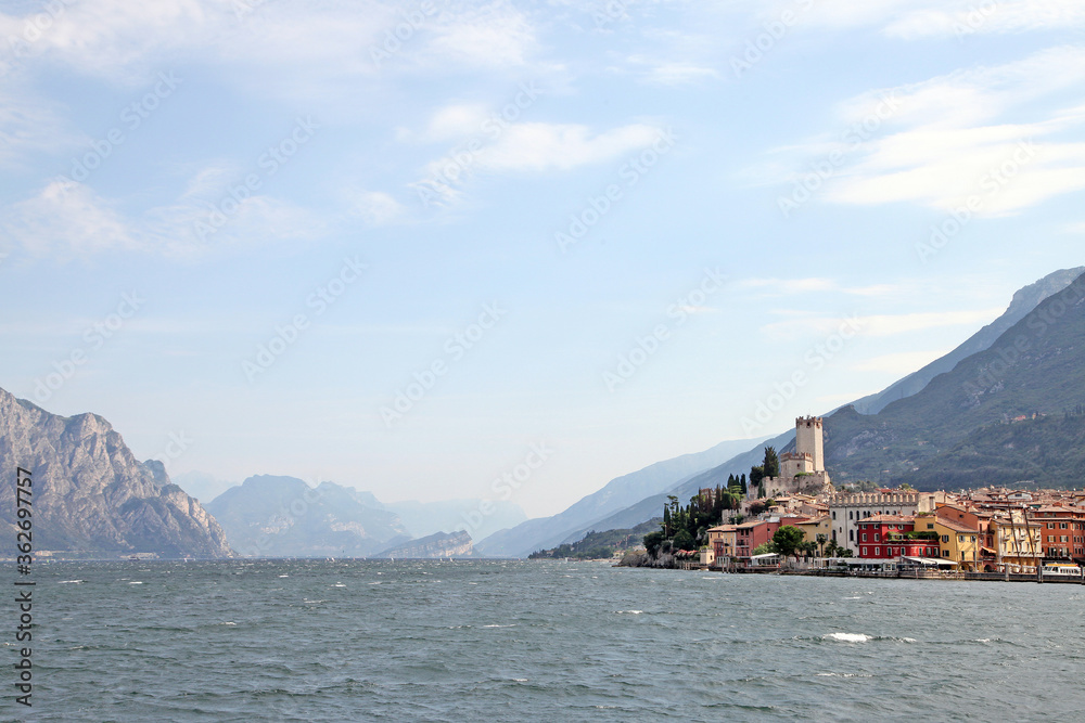 Lake Garda, in northern Italy surrounded by hills and villages with boats in the water