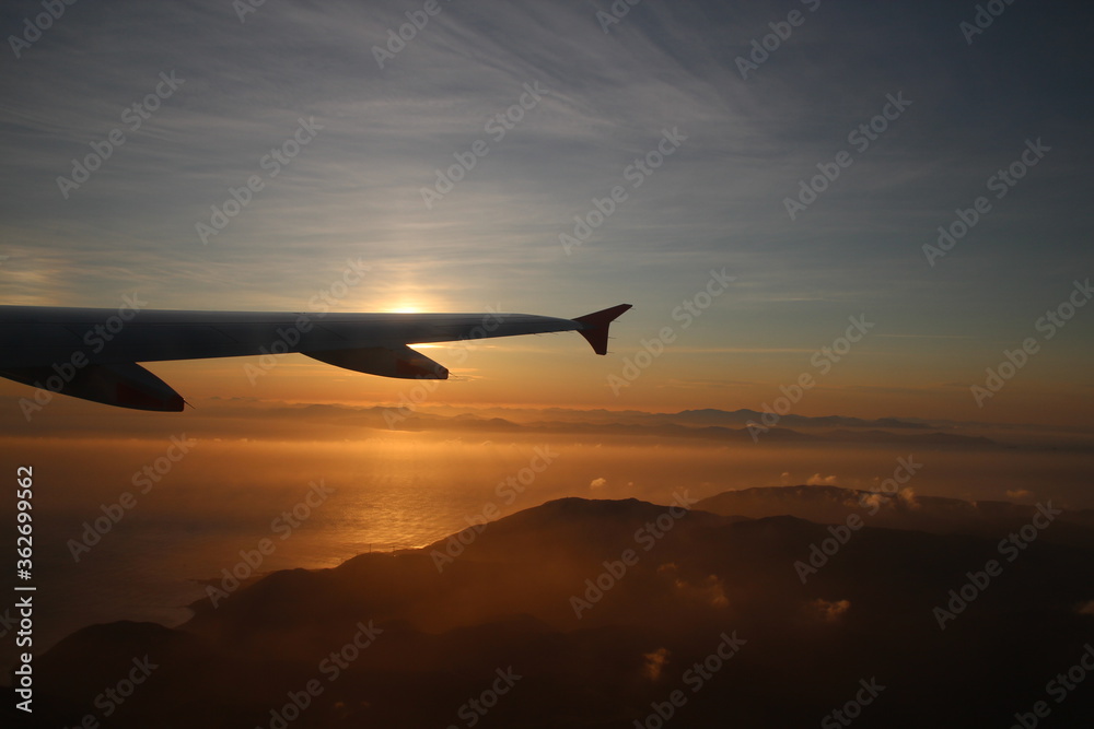 Airplane wing during sunset Airplane wing during sunset